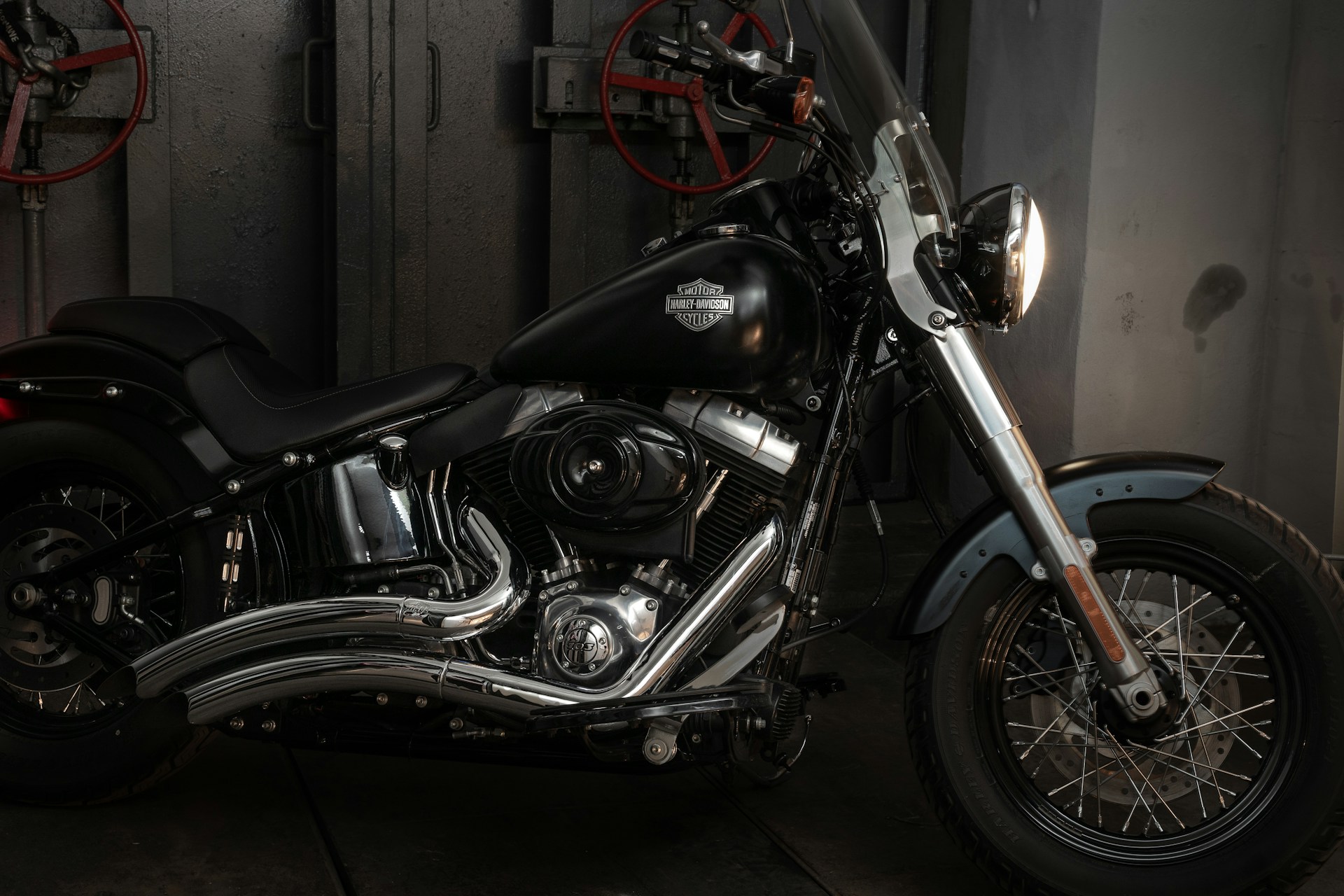 A black motorcycle in a dimly lit garage