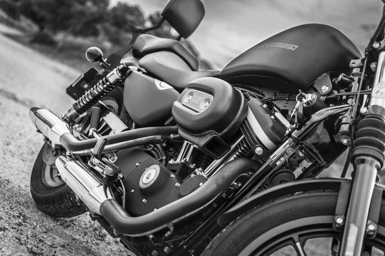 Harley-Davidson motorcycle parked outside with custom exhaust pipes