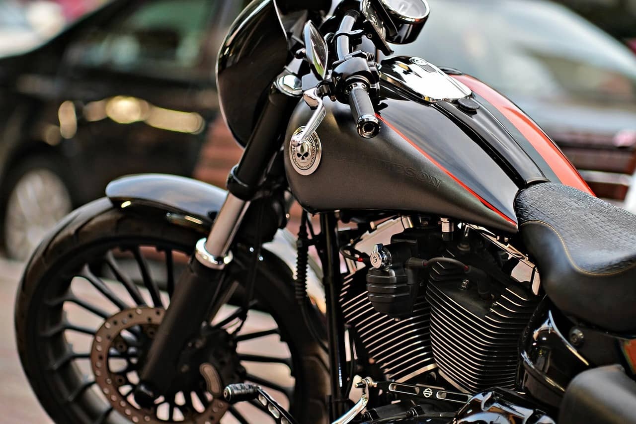 A black and red Harley-Davidson parked on a street