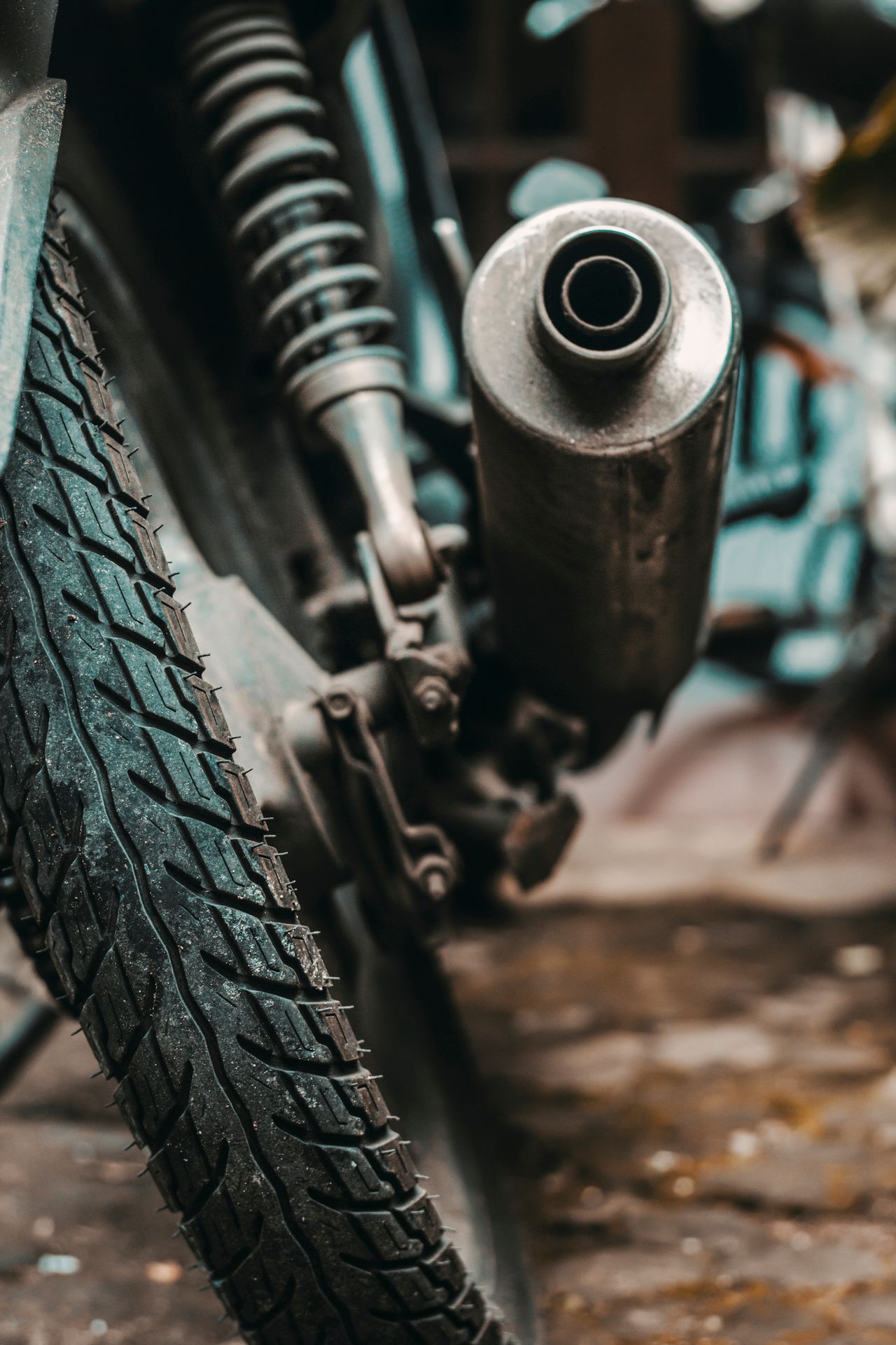 Close-up of a motorcycle exhaust system and rear wheel