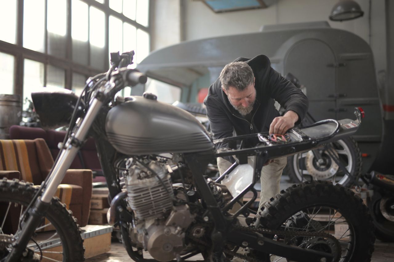 Mechanic checking a motorcycle after an exhaust upgrade