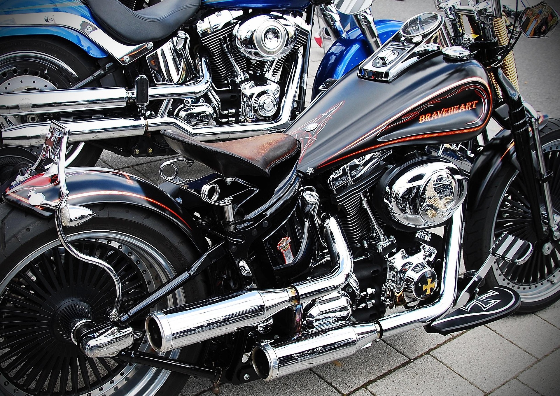 A Harley Davidson motorcycle featuring chrome pipes and a leather seat