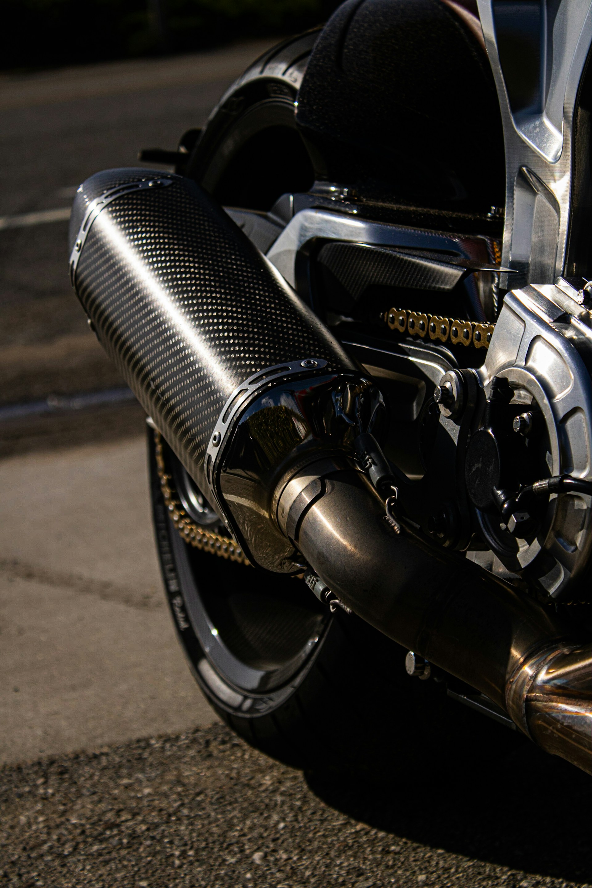Close-up of a chrome motorcycle slip-on exhaust Close-up of a chrome motorcycle slip-on exhaust